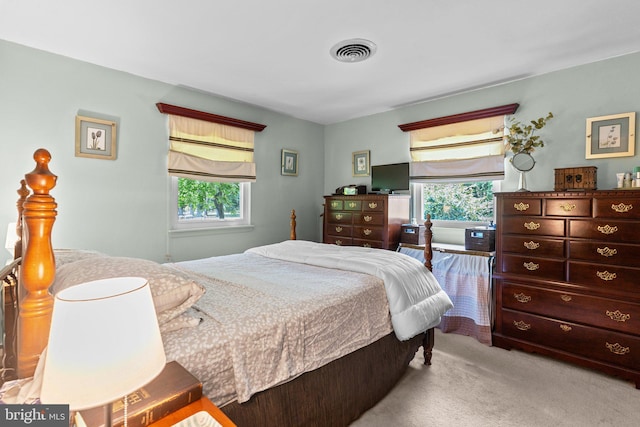 bedroom featuring light colored carpet