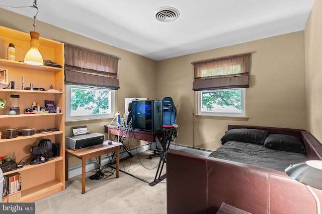 bedroom with light colored carpet and a baseboard heating unit