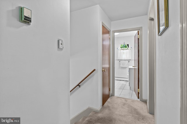 hallway featuring light tile patterned floors and a baseboard radiator