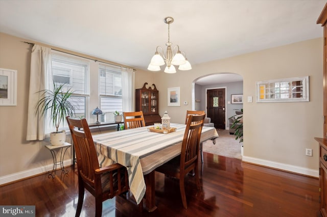 dining room featuring a notable chandelier and dark hardwood / wood-style floors