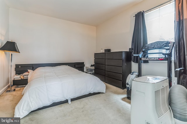 bedroom featuring light carpet and lofted ceiling