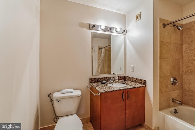 full bathroom with toilet, tiled shower / bath, and vanity