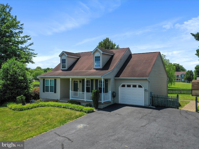 cape cod home featuring covered porch, a front yard, and a garage