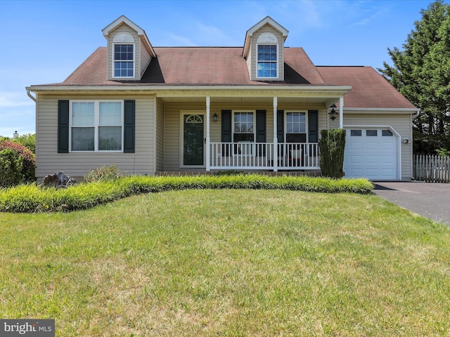 cape cod-style house with covered porch, a front yard, and a garage