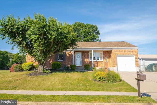 view of front of home featuring a front yard and a garage