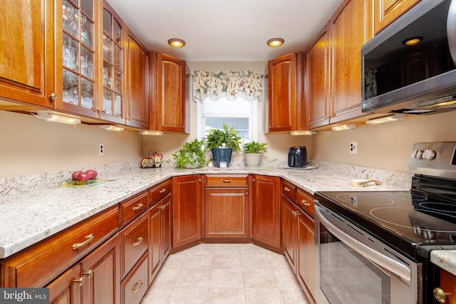 kitchen featuring light stone counters and appliances with stainless steel finishes