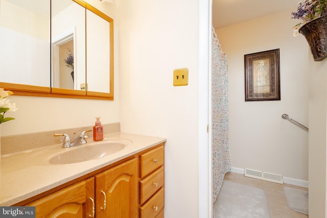 bathroom with tile patterned flooring and vanity