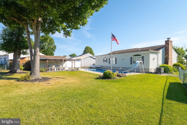 view of yard featuring a fenced in pool, central AC, and a patio