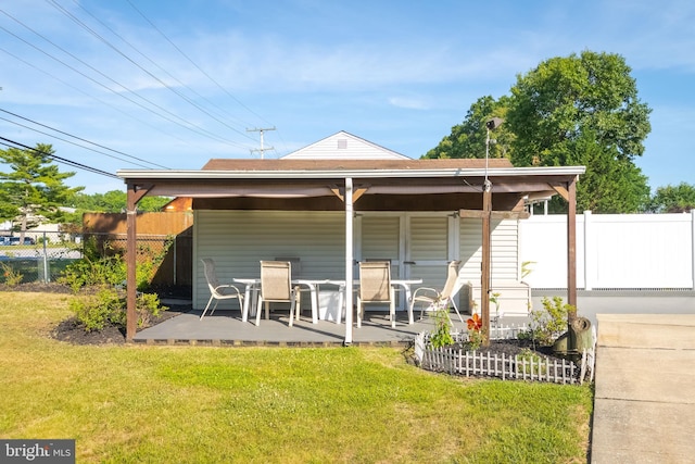 rear view of house featuring a yard and a patio area