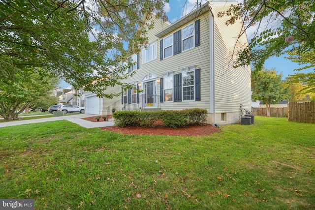 view of front facade with a garage, central AC unit, and a front lawn