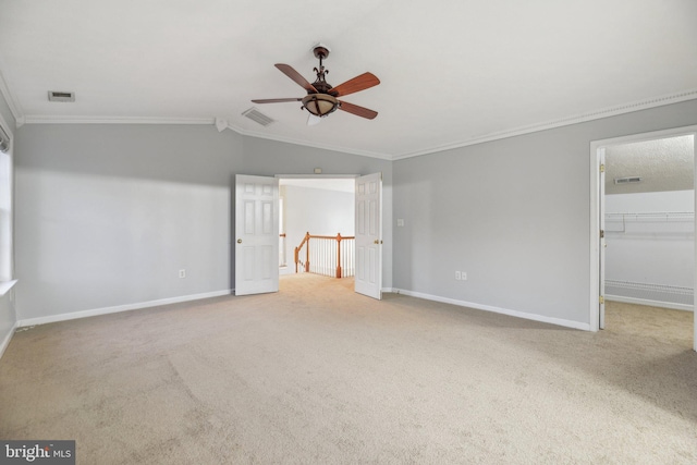 unfurnished bedroom with lofted ceiling, ornamental molding, and carpet flooring