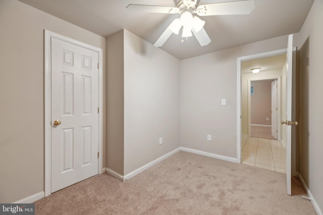 unfurnished bedroom featuring light carpet and ceiling fan