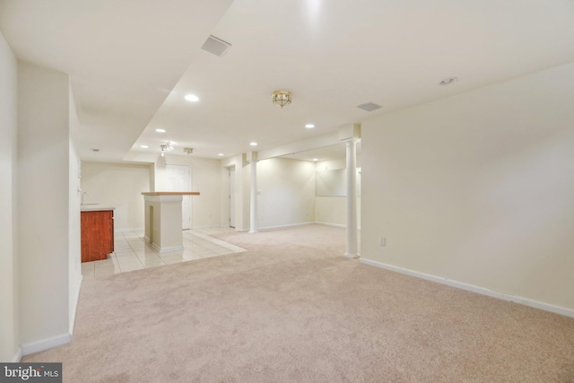 basement featuring light carpet