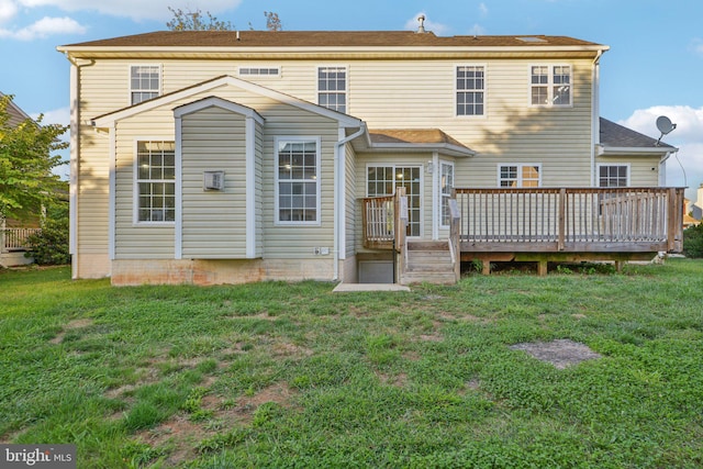 rear view of house featuring a yard and a deck