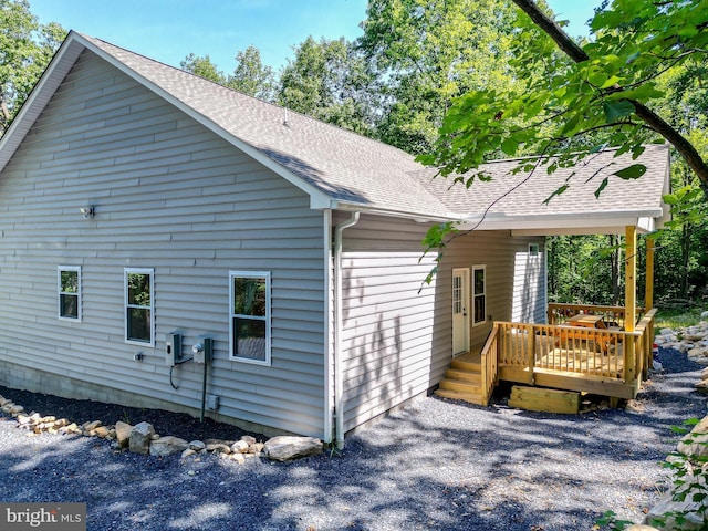 back of property featuring a wooden deck