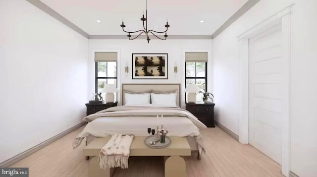 bedroom with light wood-type flooring, an inviting chandelier, and crown molding