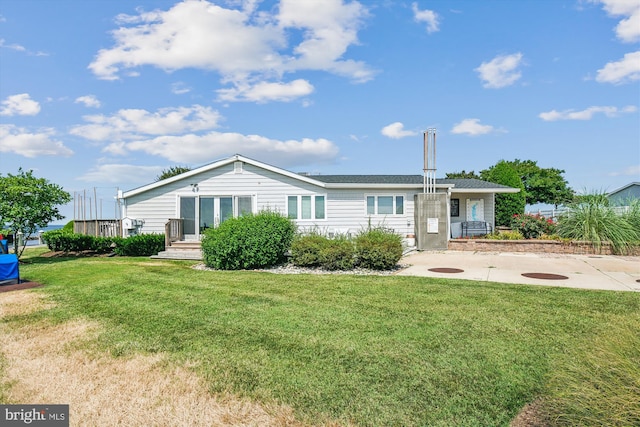 rear view of house with a lawn