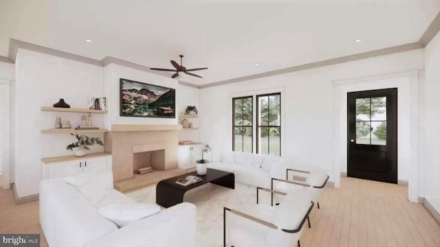 living room featuring light hardwood / wood-style flooring, ceiling fan, and crown molding