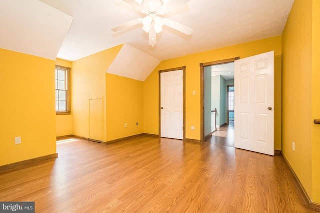 bonus room with hardwood / wood-style floors, ceiling fan, plenty of natural light, and vaulted ceiling