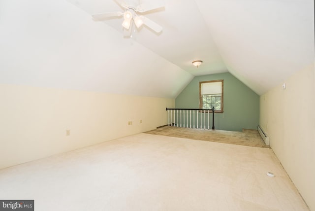 bonus room with ceiling fan, vaulted ceiling, light carpet, and a baseboard heating unit