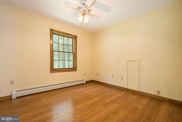 unfurnished room featuring ceiling fan, light wood-type flooring, and a baseboard heating unit