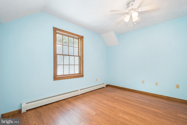 additional living space with a baseboard radiator, vaulted ceiling, ceiling fan, and light hardwood / wood-style floors