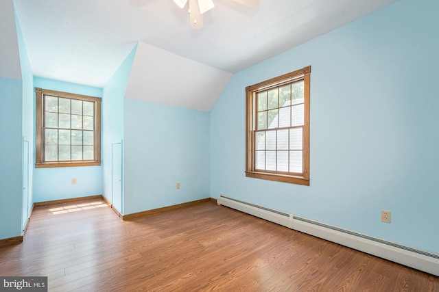 bonus room with ceiling fan, vaulted ceiling, light hardwood / wood-style floors, and a baseboard radiator