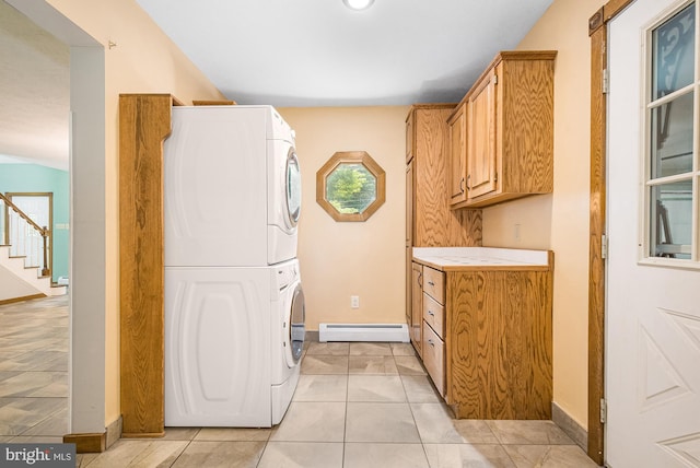 laundry room with light tile patterned floors, a baseboard radiator, and stacked washer and clothes dryer