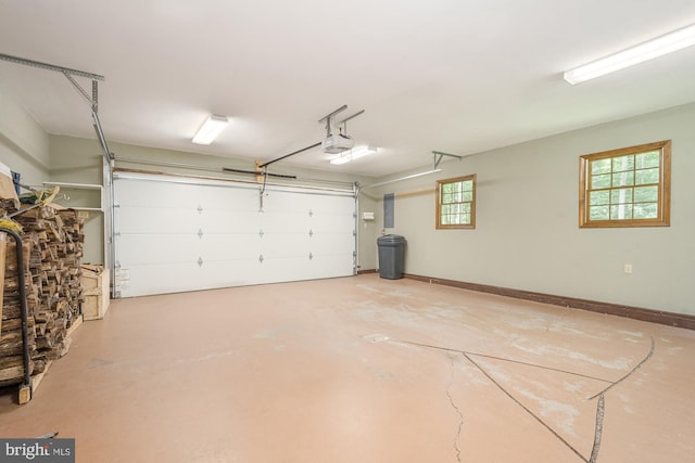 garage with electric panel and a garage door opener