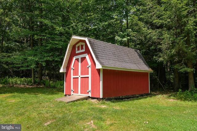 view of outbuilding featuring a lawn