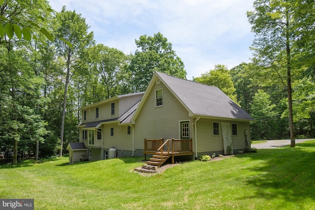 rear view of house featuring a lawn