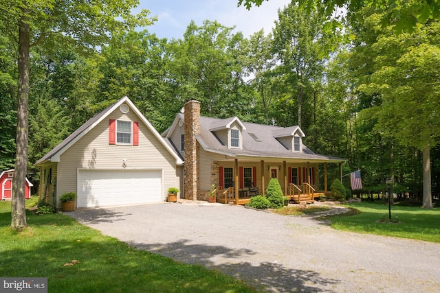 view of front facade with a porch, a garage, and a front yard