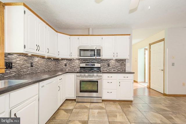 kitchen featuring appliances with stainless steel finishes, backsplash, and white cabinetry