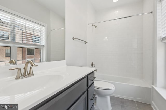 full bathroom with toilet, tiled shower / bath, tile patterned flooring, and vanity