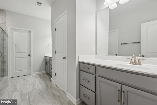 bathroom with walk in shower and vanity