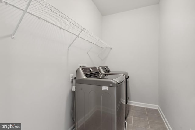 laundry area with tile patterned flooring and independent washer and dryer