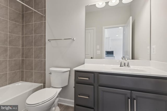 full bathroom with toilet, vanity, and tiled shower / bath