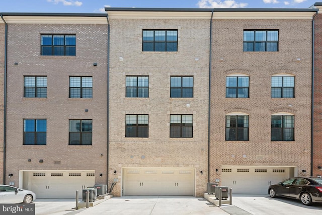 exterior space with central AC and a garage