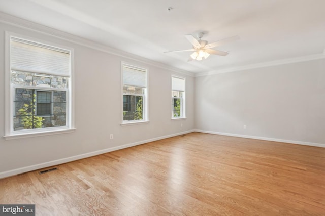 empty room with ceiling fan, crown molding, and light hardwood / wood-style flooring