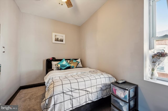 carpeted bedroom featuring multiple windows, ceiling fan, and lofted ceiling