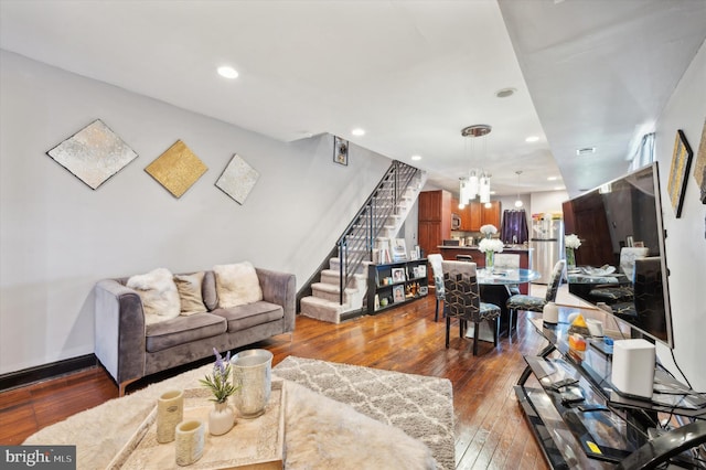 living room with a chandelier and dark hardwood / wood-style floors