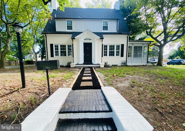 view of front of home featuring a sunroom