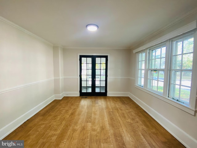 entryway featuring french doors, crown molding, and light hardwood / wood-style flooring