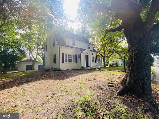 view of home's exterior featuring an outbuilding and central AC unit