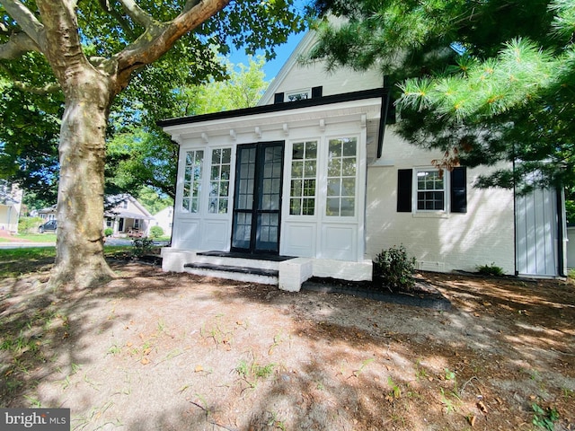 view of outdoor structure with a sunroom