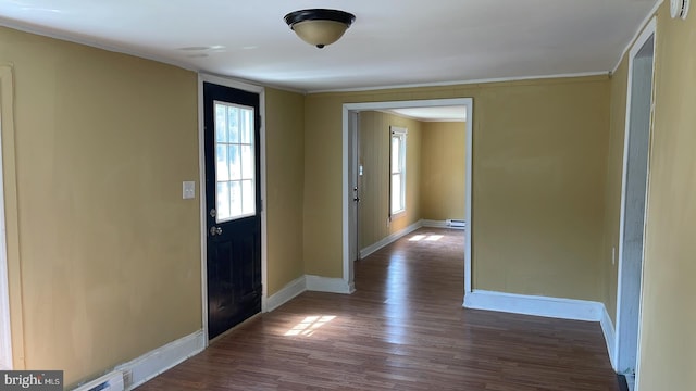 entryway with crown molding and dark hardwood / wood-style floors