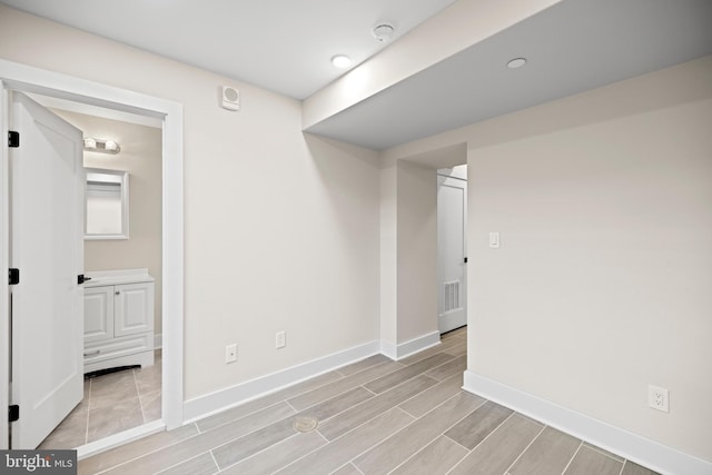 spare room with visible vents, baseboards, and wood tiled floor