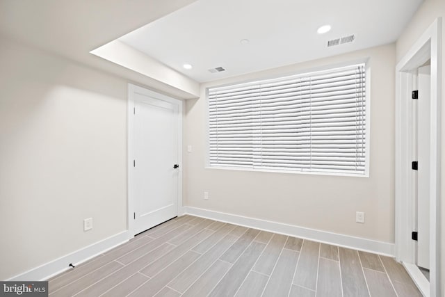 interior space with recessed lighting, visible vents, baseboards, and wood tiled floor