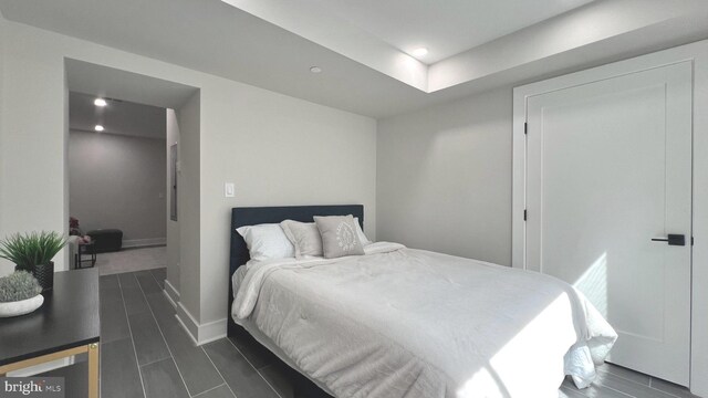 bedroom with recessed lighting, baseboards, and wood finish floors