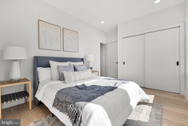 bedroom with a closet and light wood-type flooring